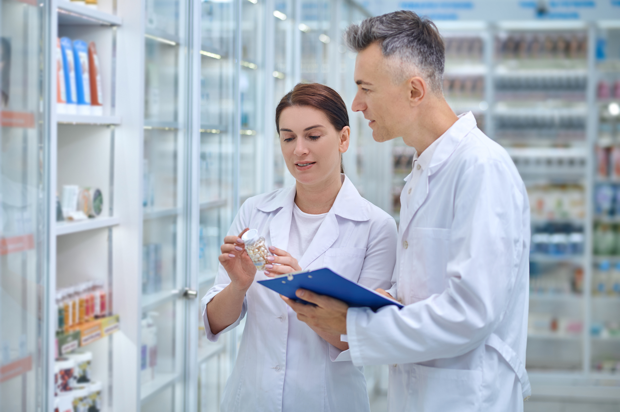revision-dos-farmaceuticos-haciendo-revision-de-medicamentos-en-una-farmacia